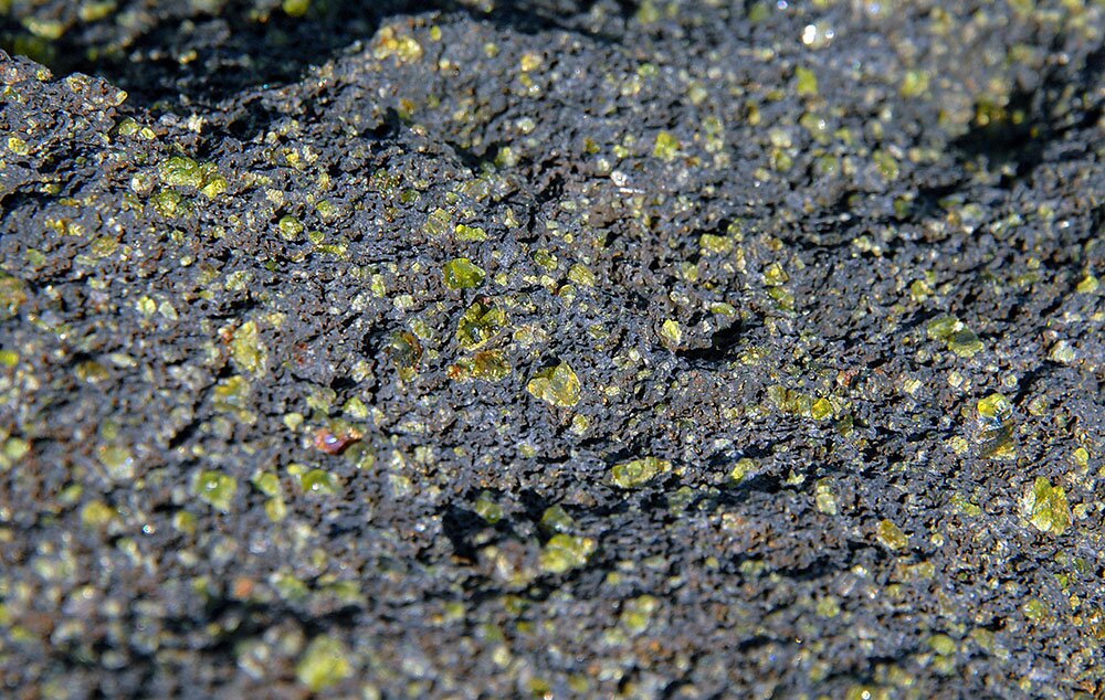 Кристаллы оливина в вулканическом туфе зелёного пляжа Папаколеа (Гавайские острова)